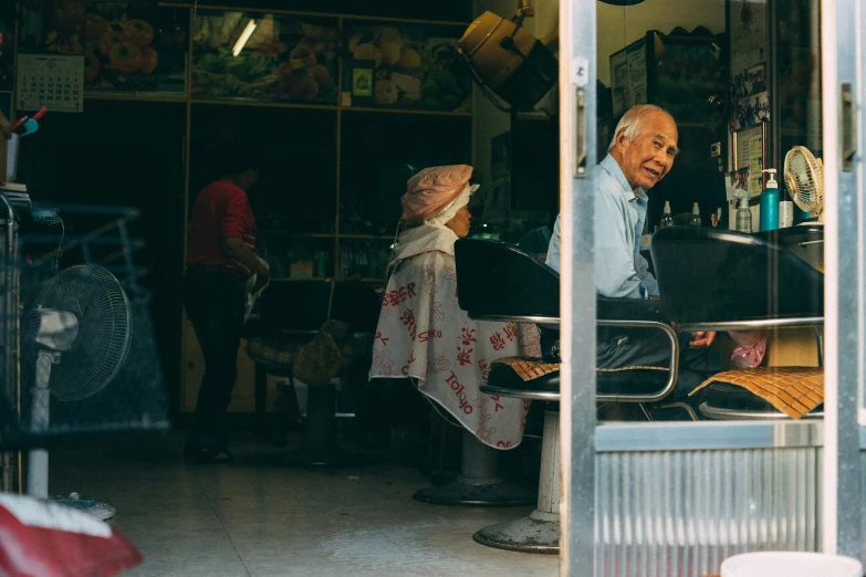 people inside of an asian bar with a table and umbrellas