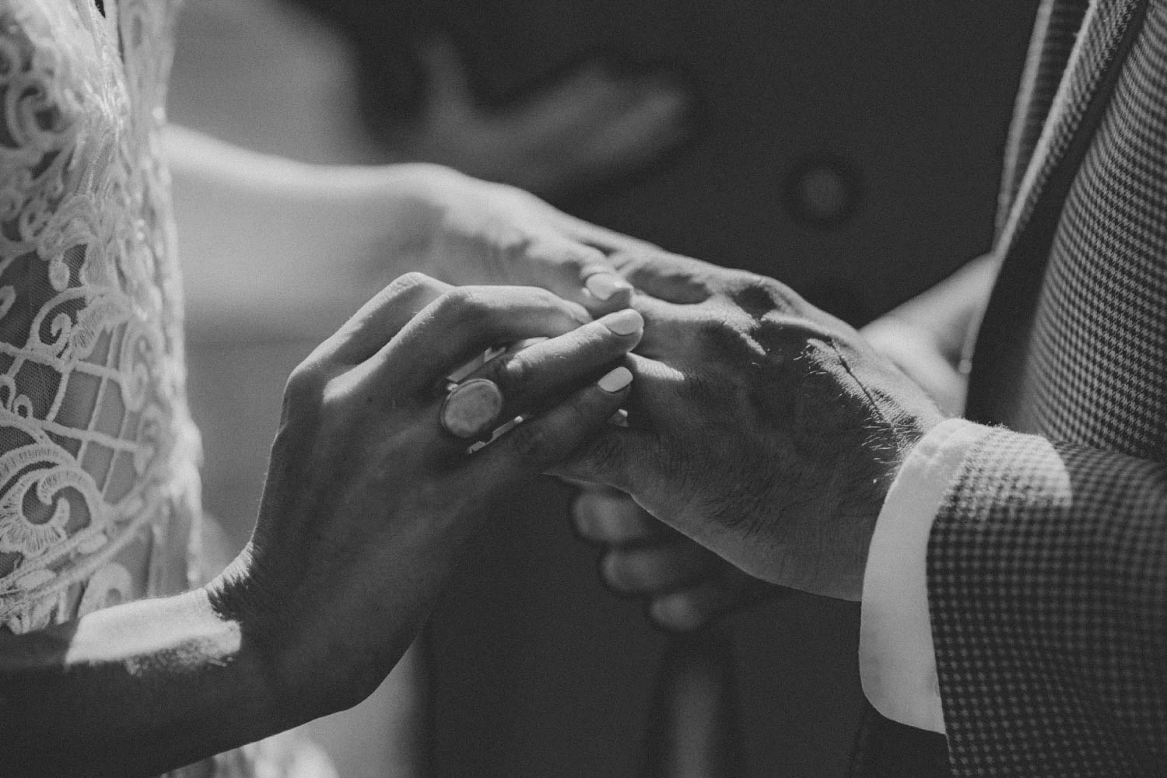 a close up view of a man and woman holding hands