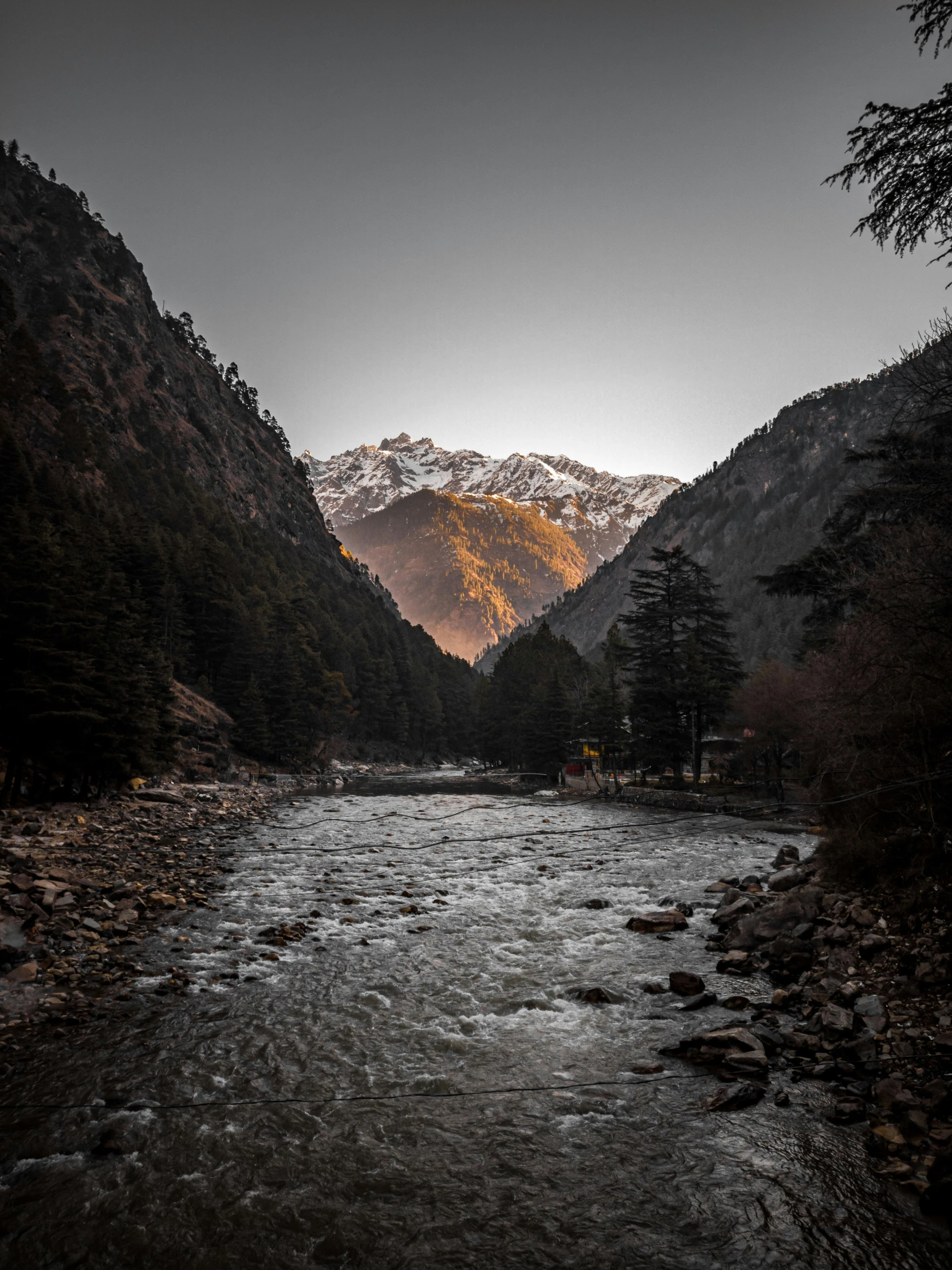 the sun is shining on a mountain valley