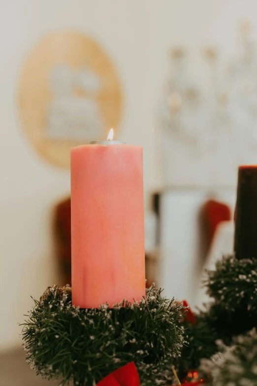 a candle is placed on top of the christmas mantle