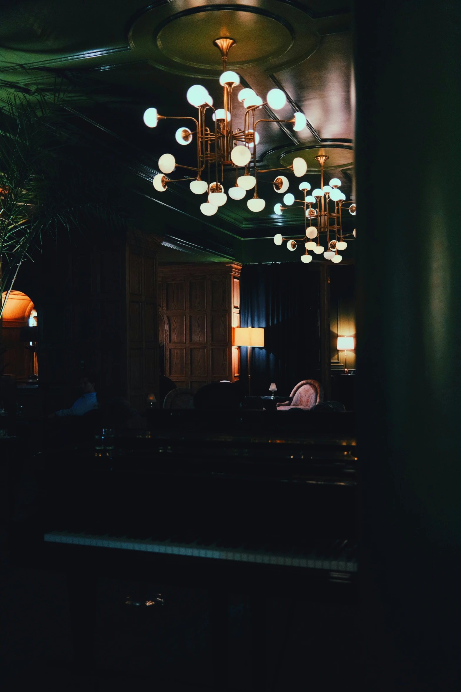 a chandelier in the middle of a dimly lit room