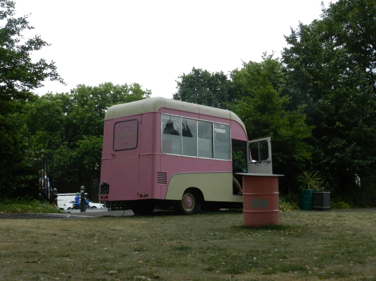 an old school bus parked on the side of the road