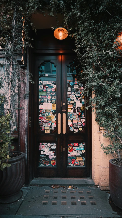 a doorway that has a lot of pictures on the glass
