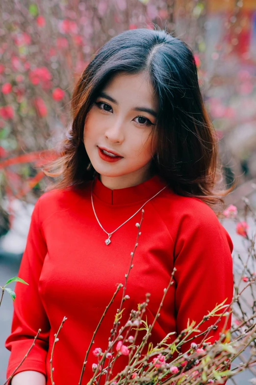 a young woman with long hair in red sweater