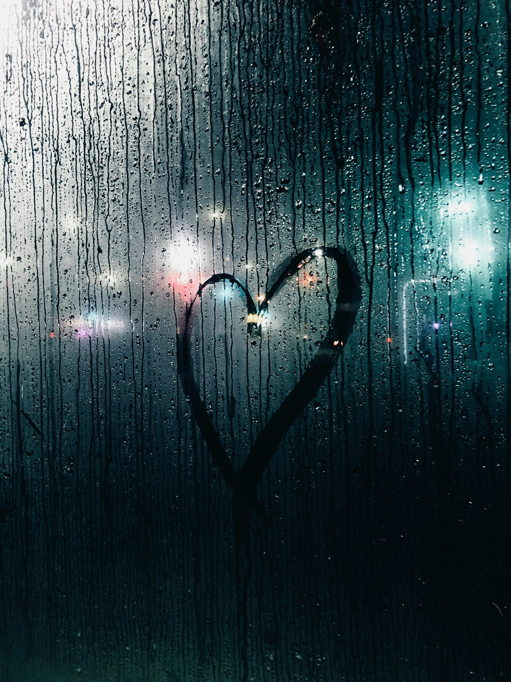the image shows a heart as raindrops fall