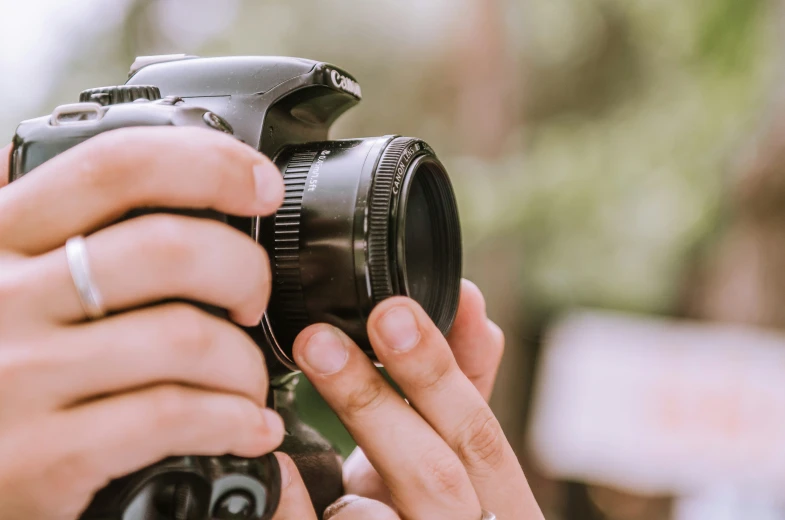 a woman holding up a camera next to her hand