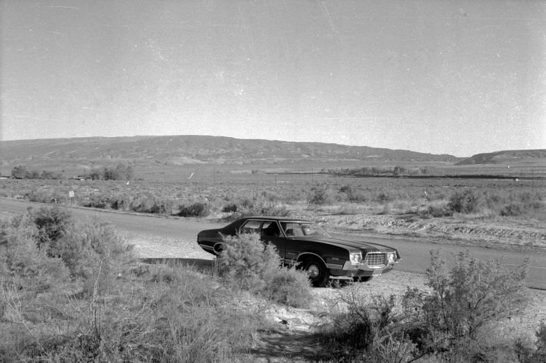 an old truck driving through the country side