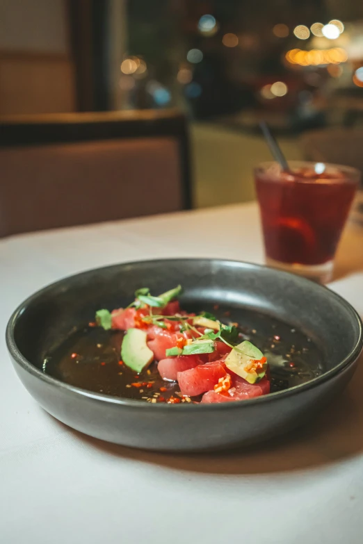 a dish of food is sitting on the table next to the cup