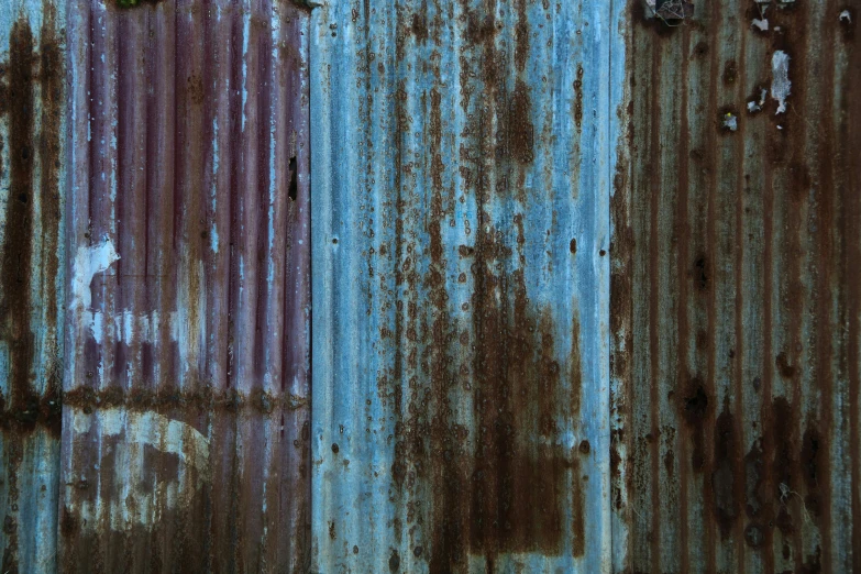 two metal panels that are rusted and stained