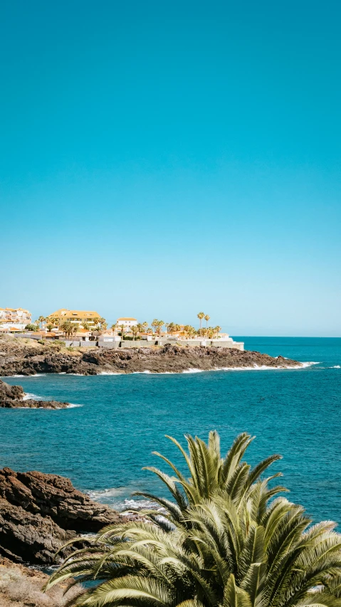 the blue water with a view of houses and trees