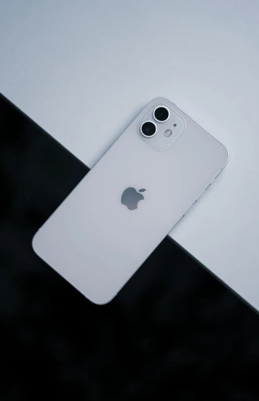 an apple phone on a table with it's camera reflected in the case