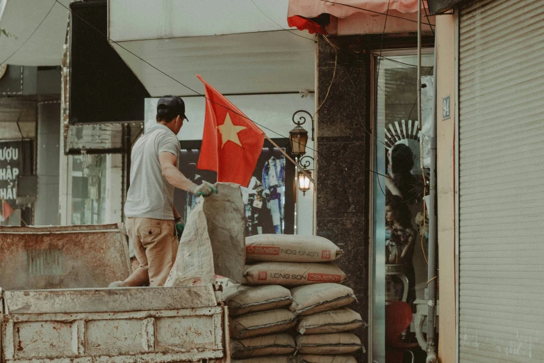 a man with two bags of sand and two flags