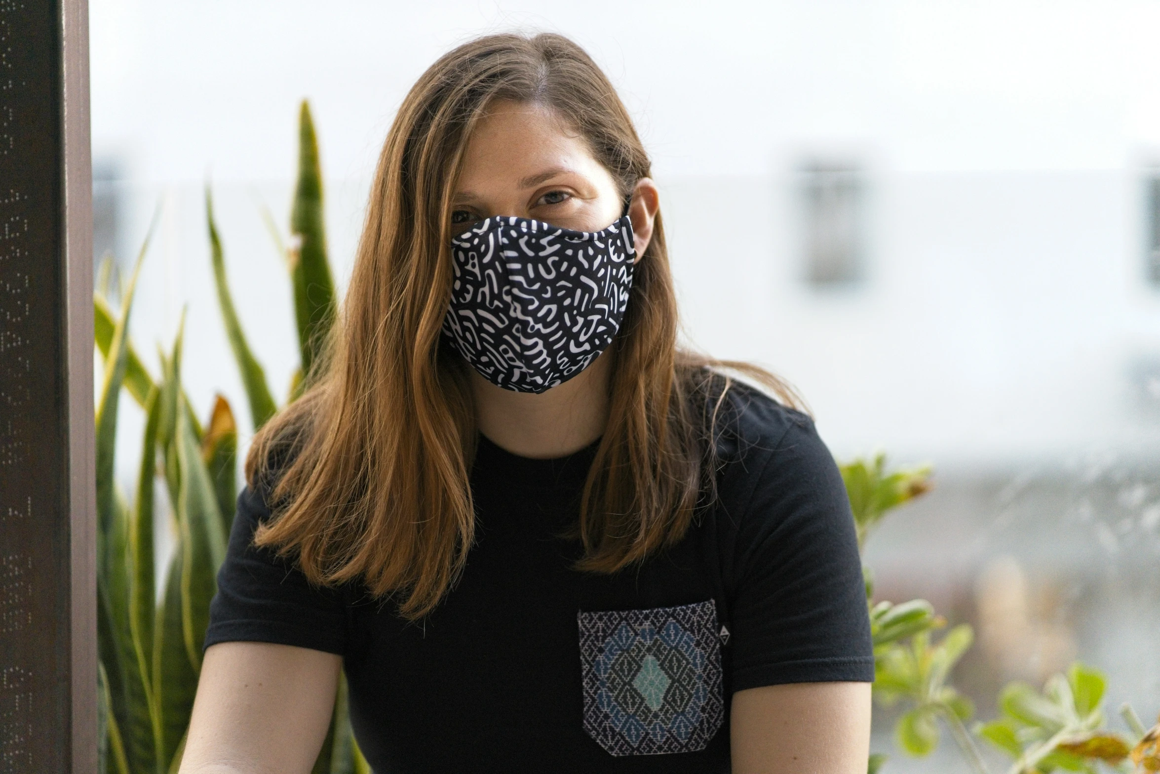 woman wearing face mask with black and white pattern