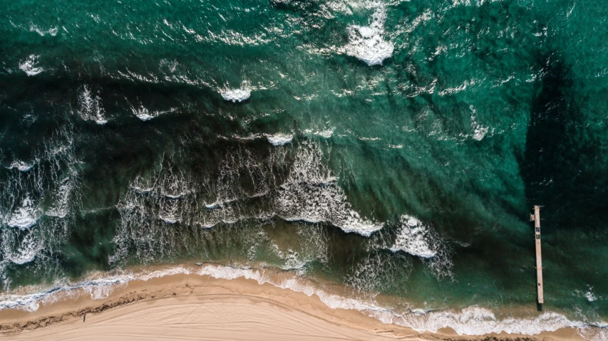 an aerial view of the ocean and beach