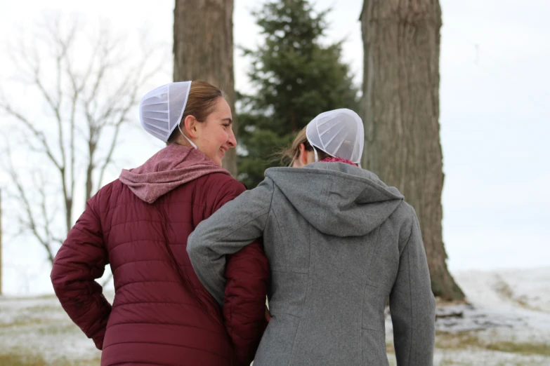 two woman in warm coats looking off into the distance