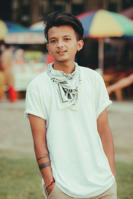 a boy poses for a po while wearing a bandana