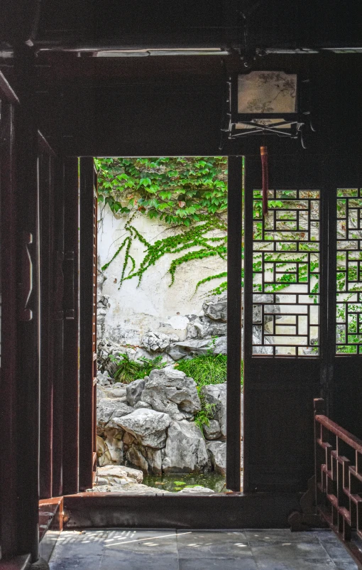 an open door into a lush green area with a river