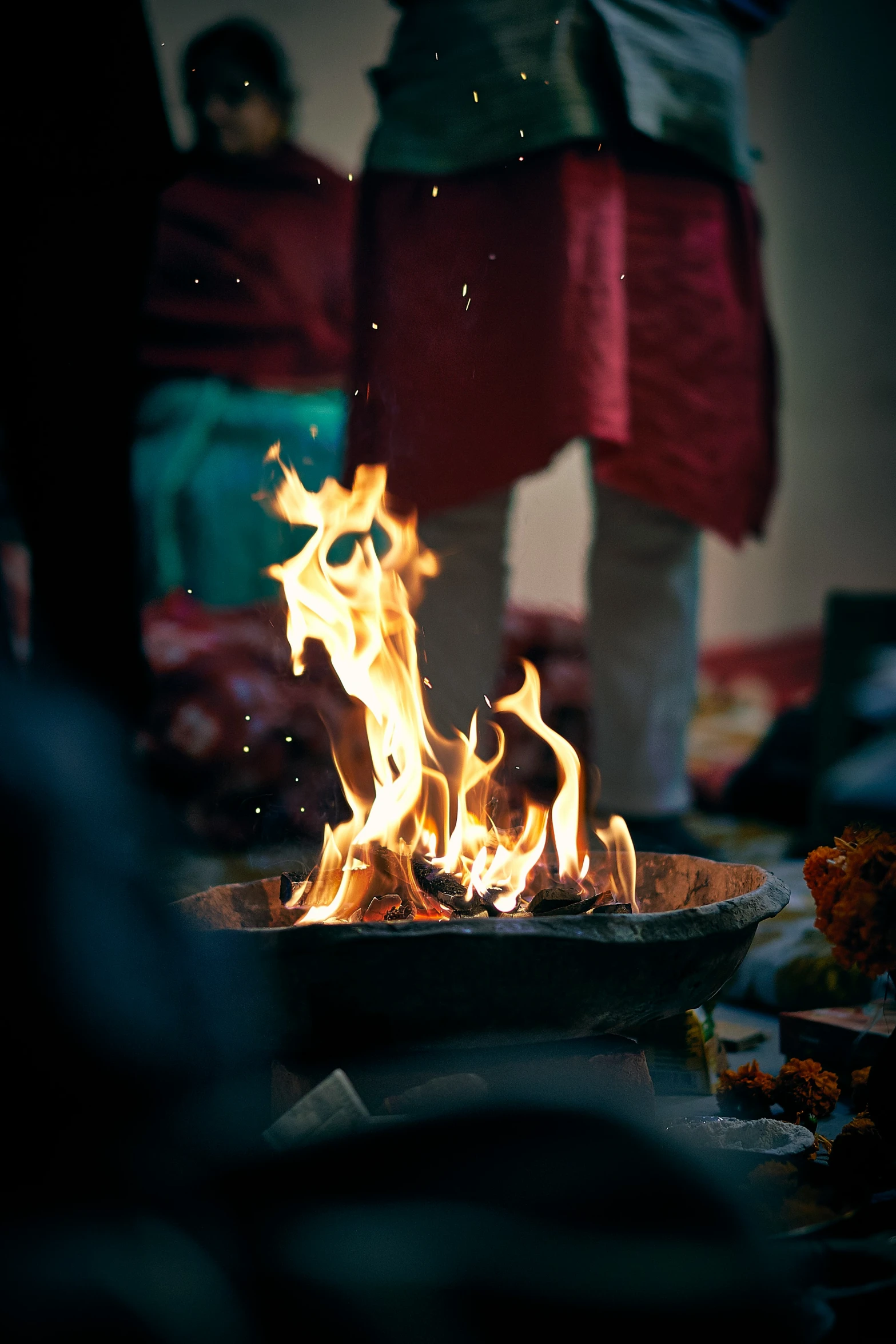 fire flames on a tray with someone standing in the background
