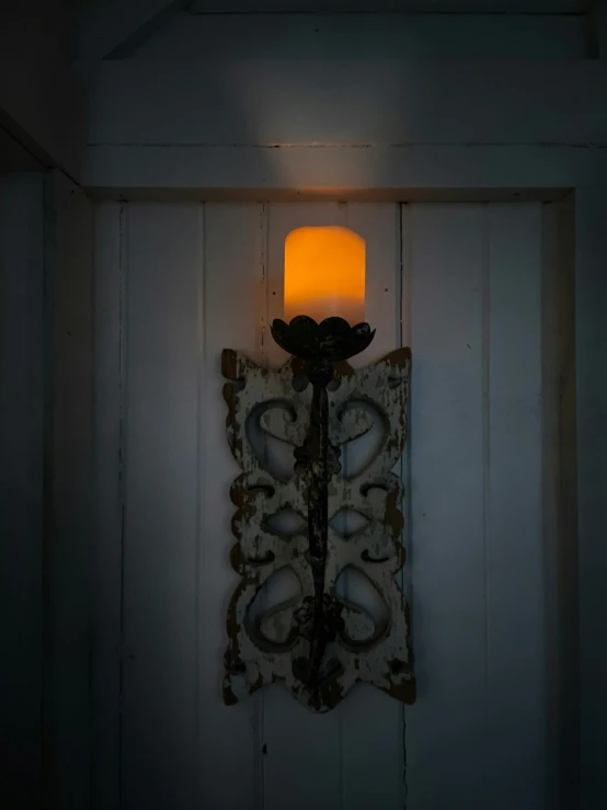 a lit wall sconce is seen at night