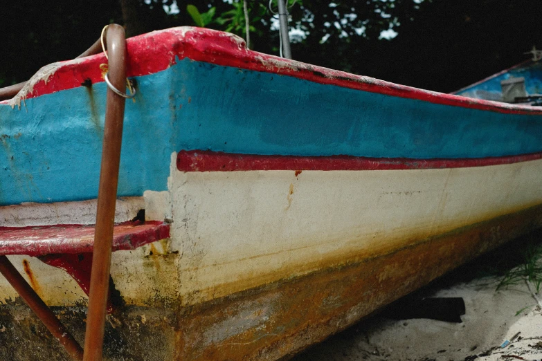two row boats that are sitting in the sand