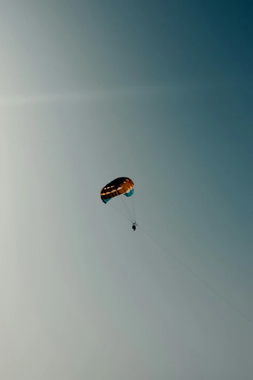 the person is being pulled up into the sky by a parachute