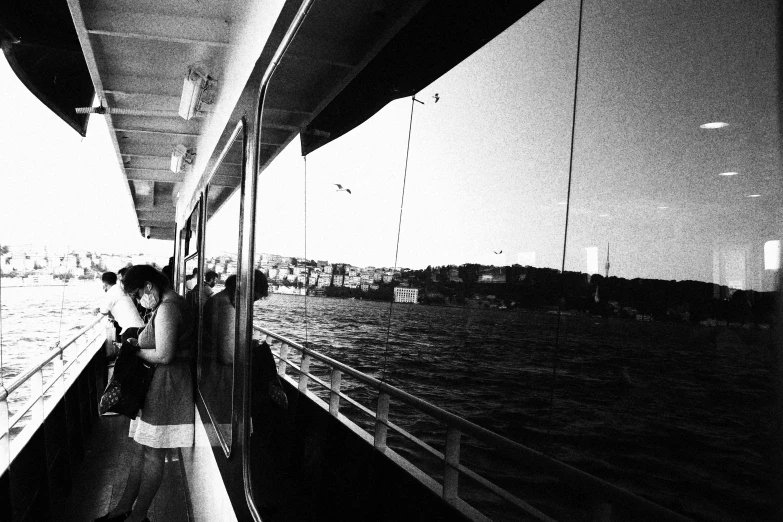 a person riding in the back of a boat looking out