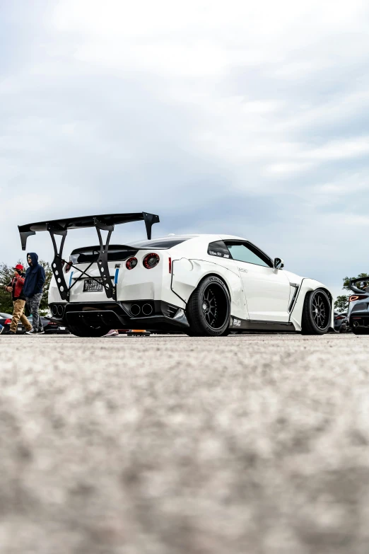 some white cars are sitting side by side in a parking lot