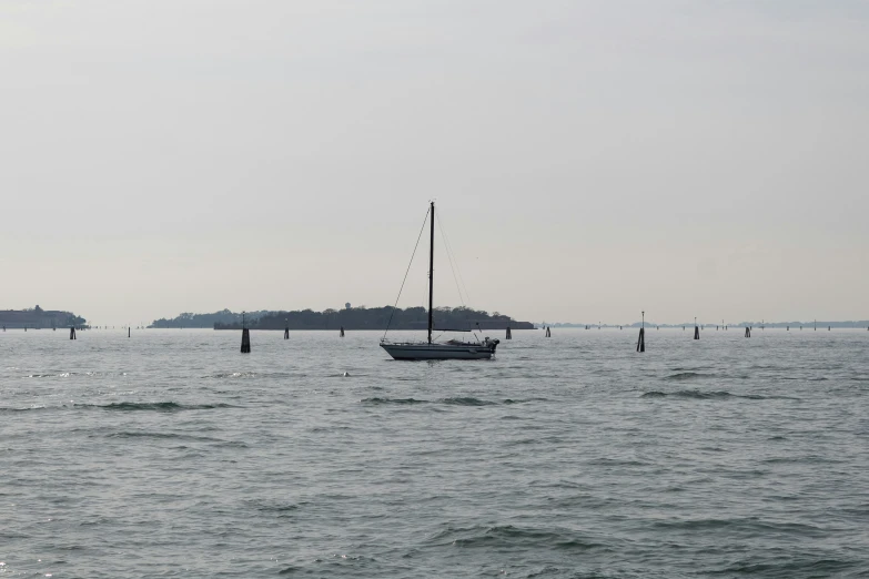 sailboats are out on the water in the distance