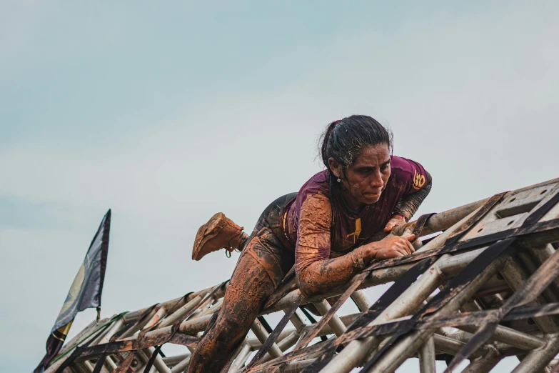 a man in red and white climbing on a wooden structure