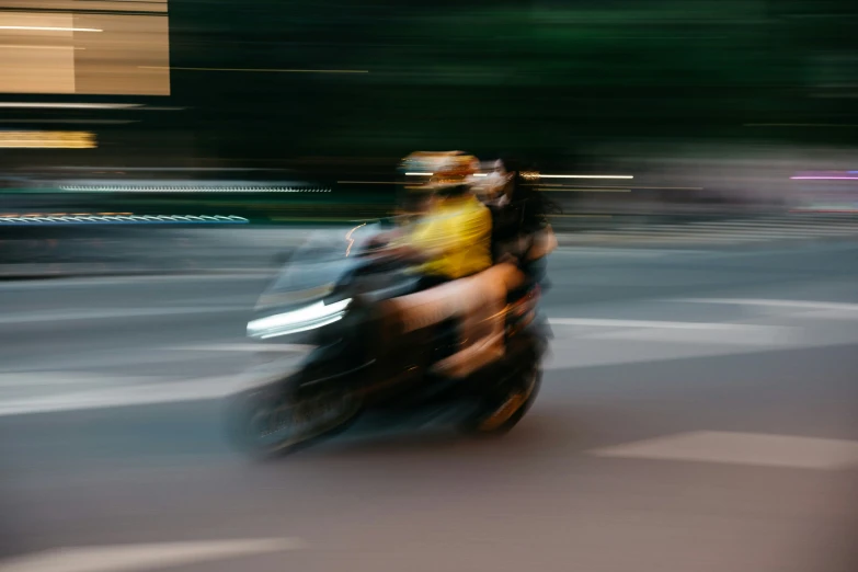 two people are riding on the back of their motor cycle