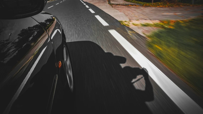 the view of a car driving on a road in the day time