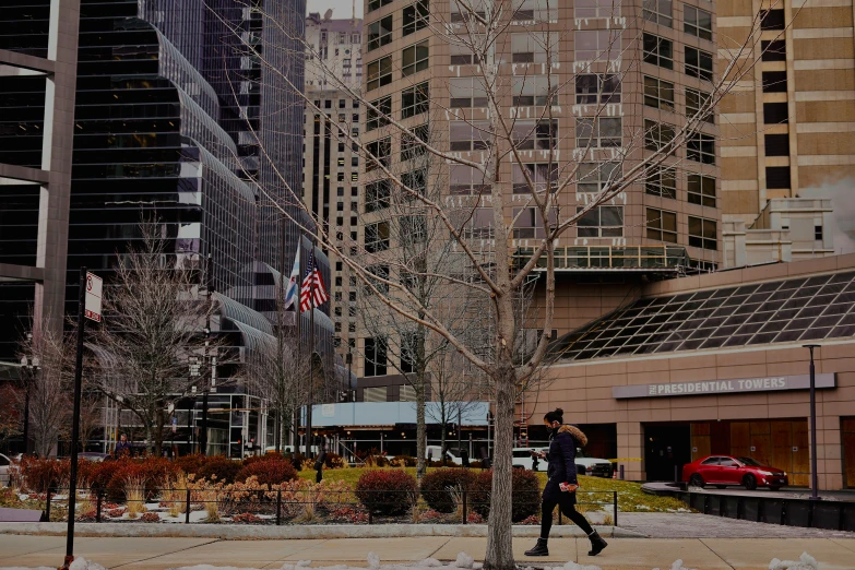 people are jogging down the sidewalk in a city