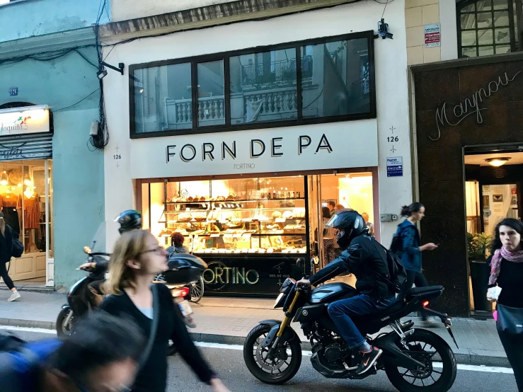 people walking around the streets in front of a building