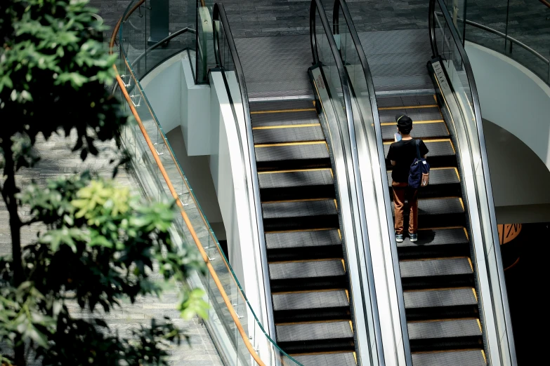 the person walking up the escalator of an empty building