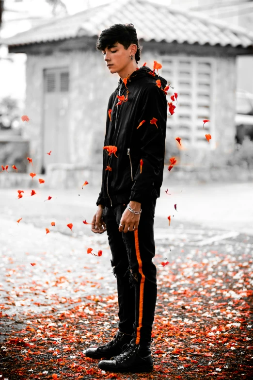 the man is walking down the street with falling petals