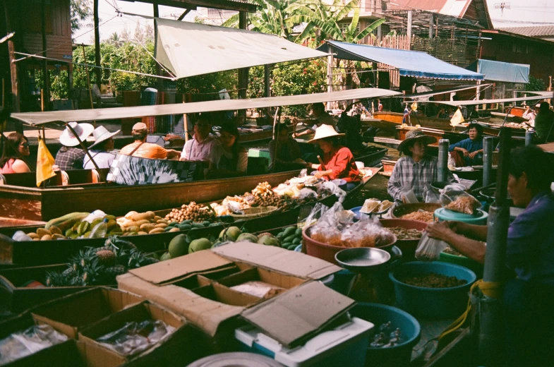 people on a boat selling goods and produce at a market