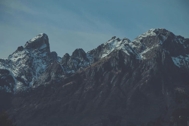 the top of the mountains covered in snow