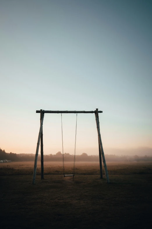 a swing set in the middle of a field