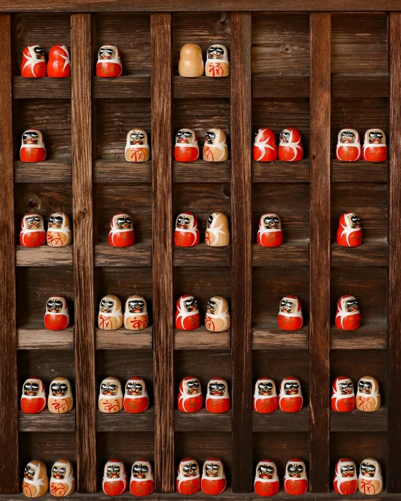 this is a display of many hand - carved pots in a wooden cabinet