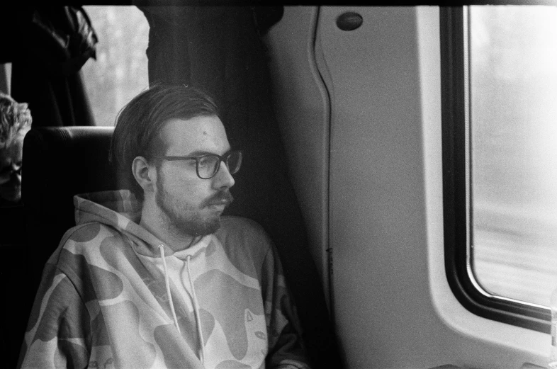 a man wearing glasses on an over sized train