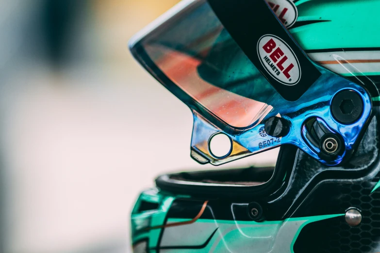 the rear view of a green motorcycle helmet with scissors on it