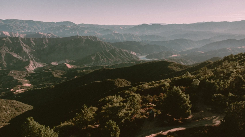 the view of the mountains and the valleys from the top of the peak