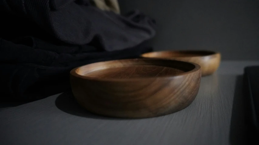 a couple of wooden bowls sitting on a table