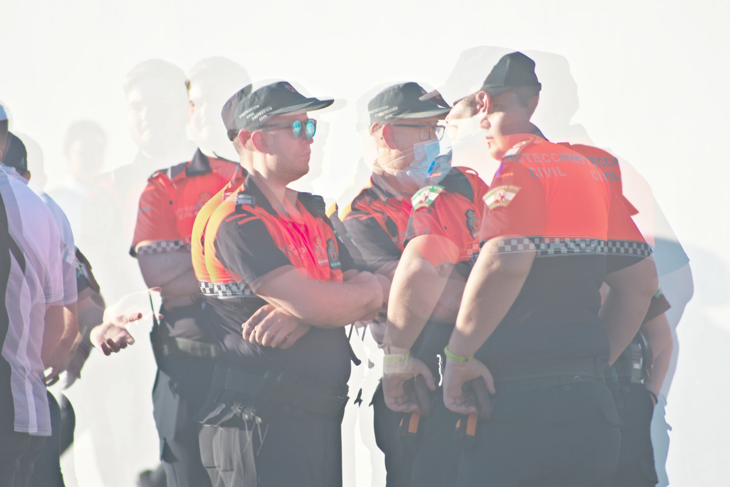 men wearing uniforms talking to each other in the middle of a crowd