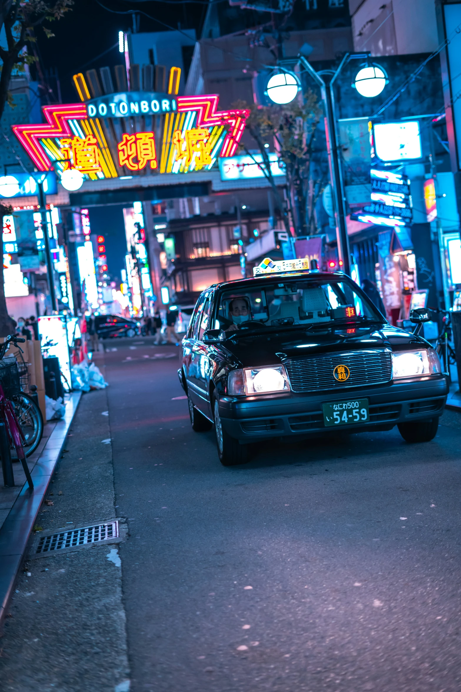 a car driving down a street at night