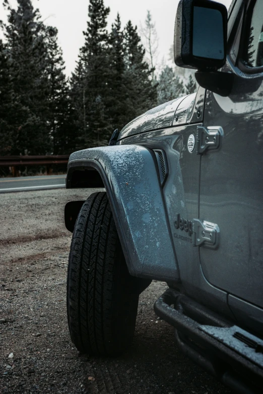 the tire of a truck with trees in the background