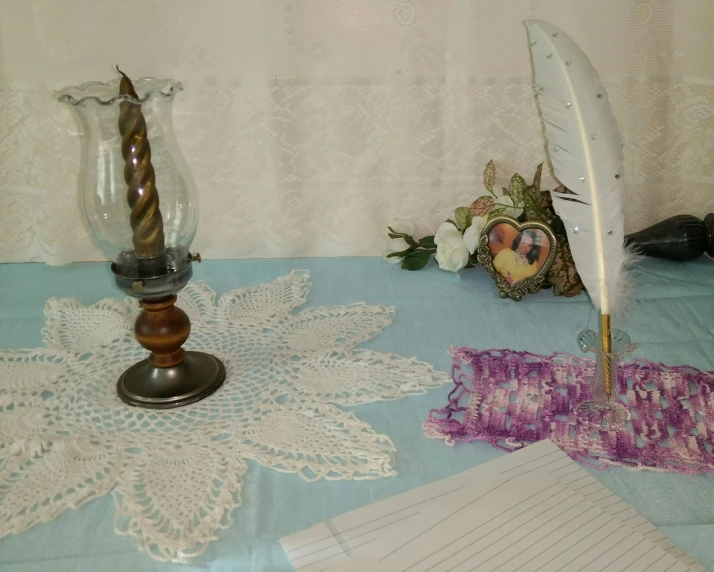 a table topped with a feather pen and two empty cards