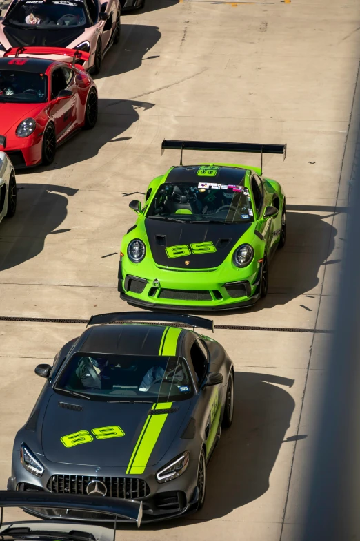 a group of three sports cars on track with race number 3 and speed number 4