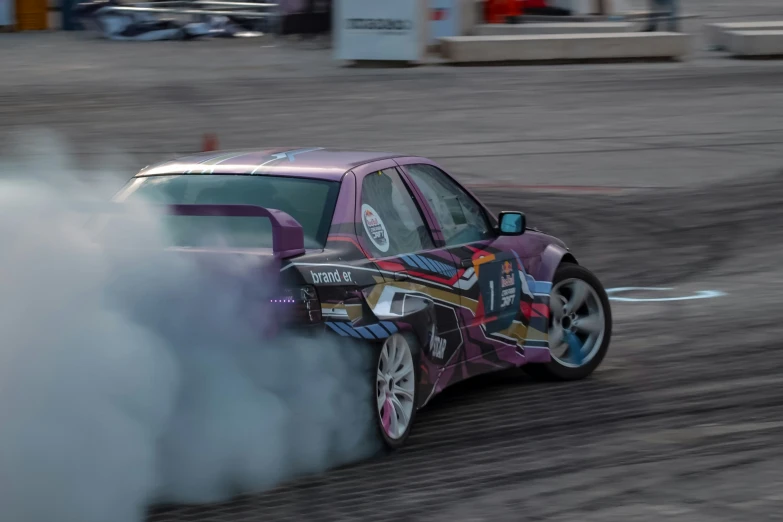 a car driving on a track covered in smoke