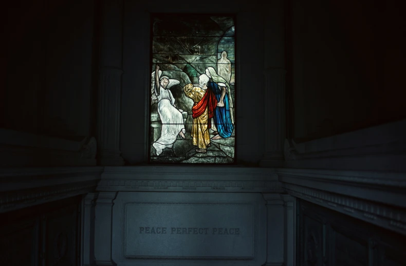 the image depicts jesus, mary, joseph and christ in stained glass